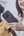 Two women looking at a phone together, one holding it.