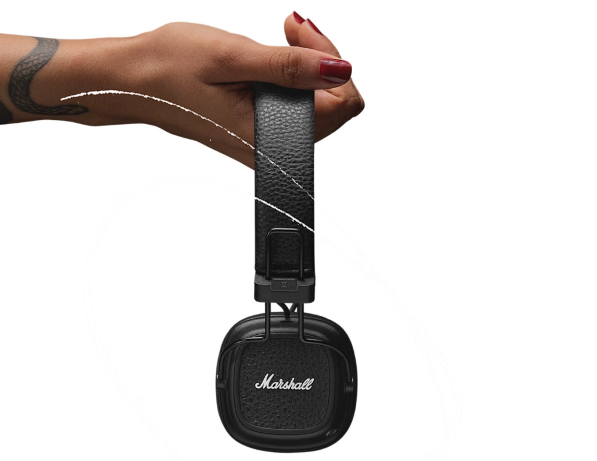Hand holding a Marshall headset with a white background