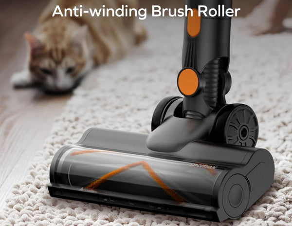 Vacuum cleaner brush roller with anti-winding feature on a carpet, with a cat in the background.