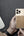Person holding a phone with a brown case, QI2 logo visible, on a dark surface.