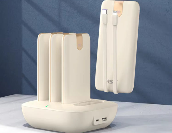 White electronic device with USB ports on a gray surface.