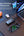 Laptop with multiple devices connected via a Vyvylabs Power Cube Pro Digital Display Power Bank 20000mAh 100W with Type-C Fast Charging Cable – VBQ10-TN on a desk.