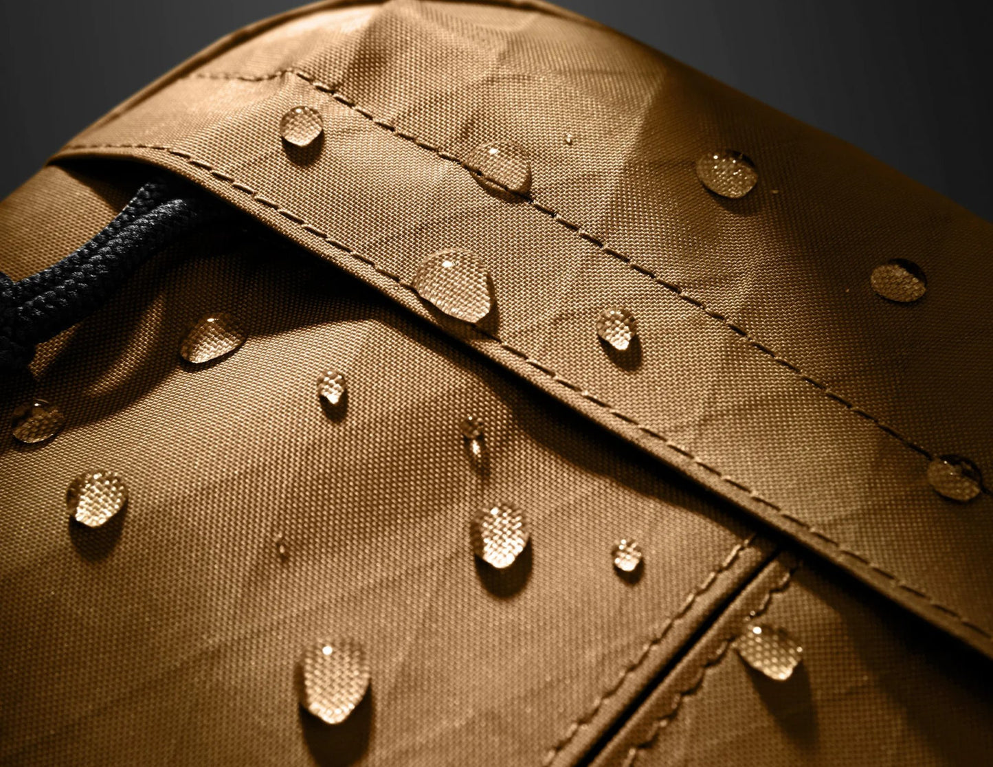 Close-up of a brown fabric surface with water droplets