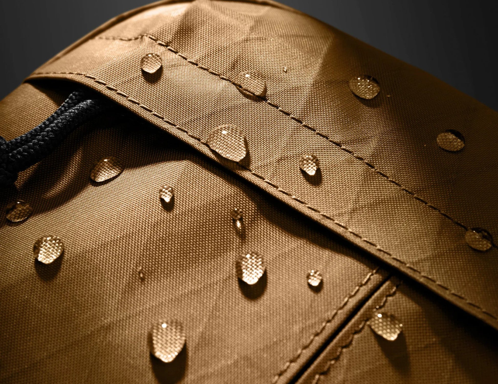 Close-up of a brown fabric surface with water droplets