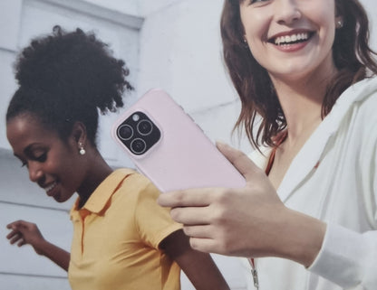 Two women holding a pink smartphone with a white background