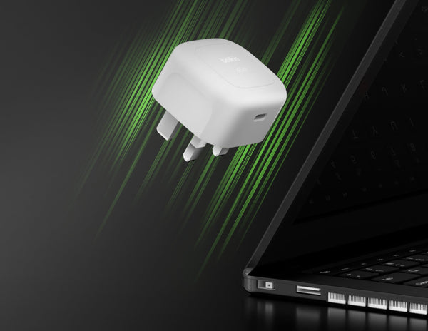 White adapter device with green light effects on a black background
