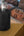 Wizard Smart Embers Incense Burner EB-30 on a wooden surface with a person lying in bed in the background.