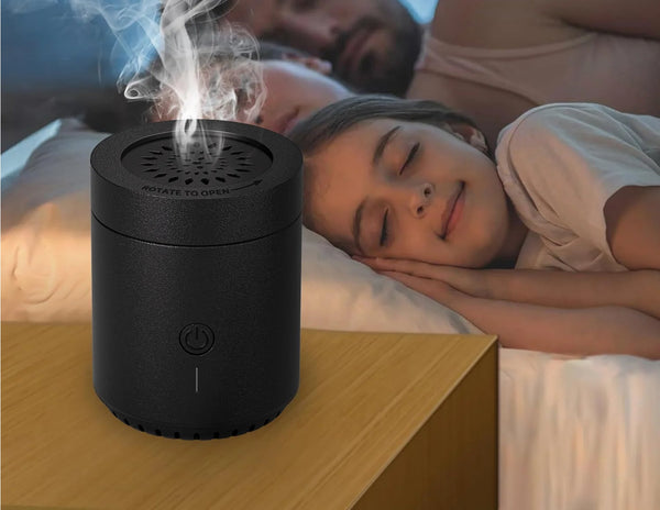 Wizard Smart Embers Incense Burner EB-30 on a wooden surface with a person lying in bed in the background.