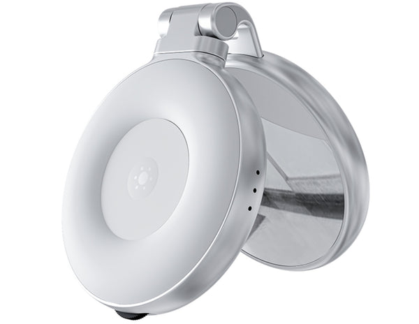 Round metallic sensor on a white background