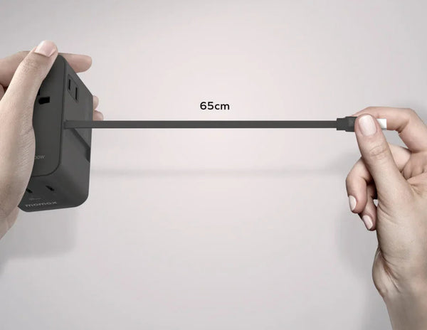 Person holding a power adapter with a cable labeled '65cm' on a light gray background