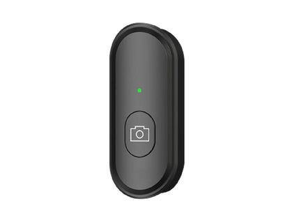 Black camera remote control with a green indicator light on a white background
