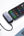 Phone connected to UGREEN Nexode 5000mAh 20W Power Bank with Built-in USB-C Connector – PB503 with laptop on a white surface