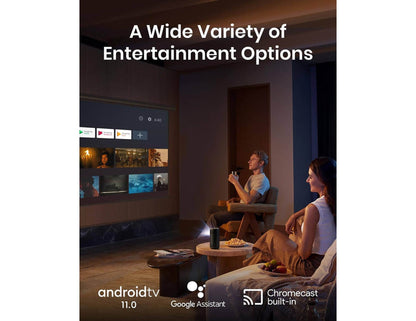 Two people sitting in a dimly lit room watching a screen displaying entertainment options with Anker Nebula Capsule 3 Laser (D2426212) - 1080p HD Portable Projector
