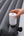 Hand holding a white pump attached to an inflatable mattress