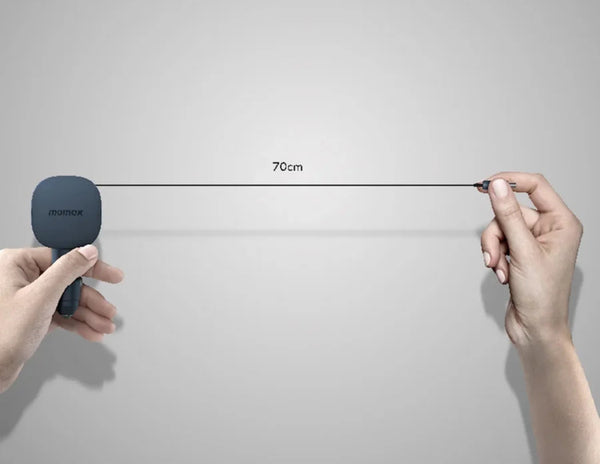 Two hands holding a measuring tool against a gray background