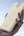 Beige wst power bank held in a hand with a sky background