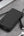 Black power bank with USB-C cable on a gray surface, featuring 'Made for iPhone' label.