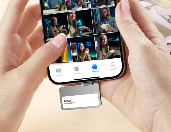 Person holding a smartphone with a video call app open, using a Lexar device on the screen.