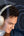 Man wearing white headphones with a dark abstract background
