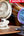 Two clip-on fans with '5 speeds wind mode' text on a blurred background