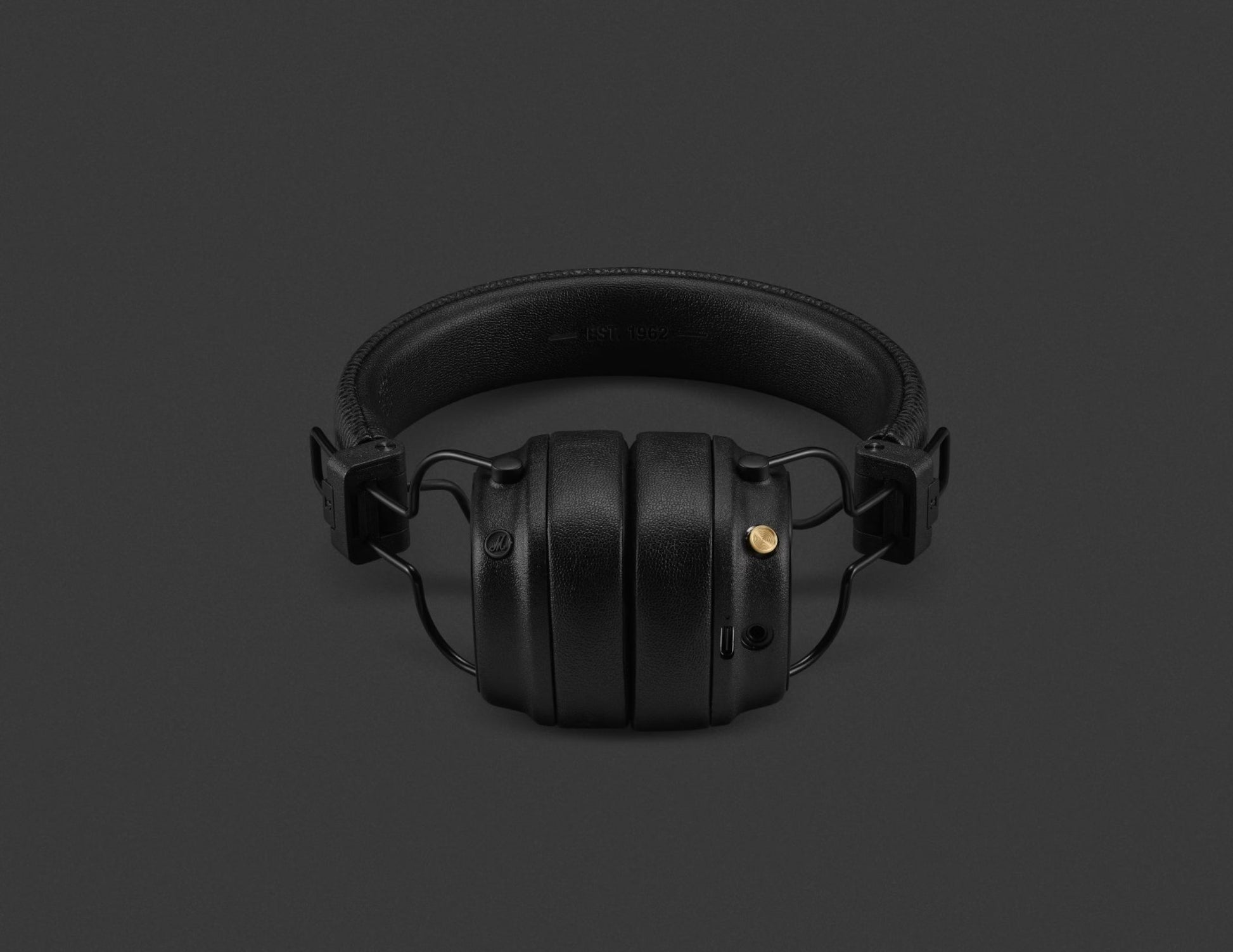 Black over-ear headphones on a dark gray background