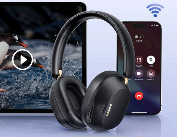 Black headphones with a tablet and smartphone displaying multimedia content on a light blue background