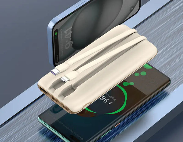White charging cable with smartphone and laptop on a reflective surface