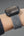 Smartwatch with a textured band on a person's wrist.