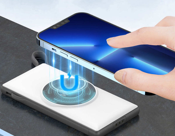 Wireless charging Power Bank with a hand placing a smartphone on it.