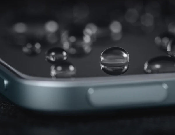 Close-up of water droplets on a smartphone screen.