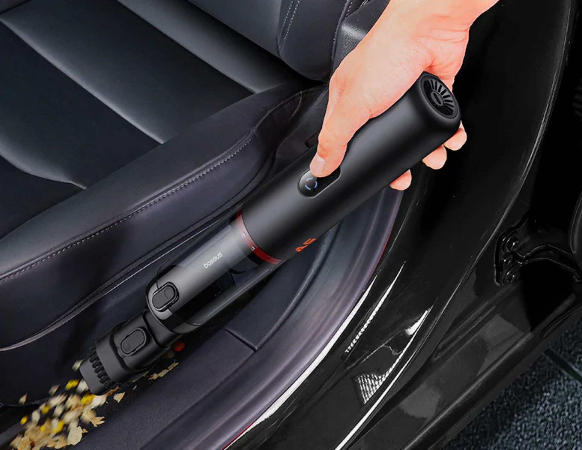 Baseus A5 Car Vacuum Cleaner being used to clean tight spaces in a car interior.