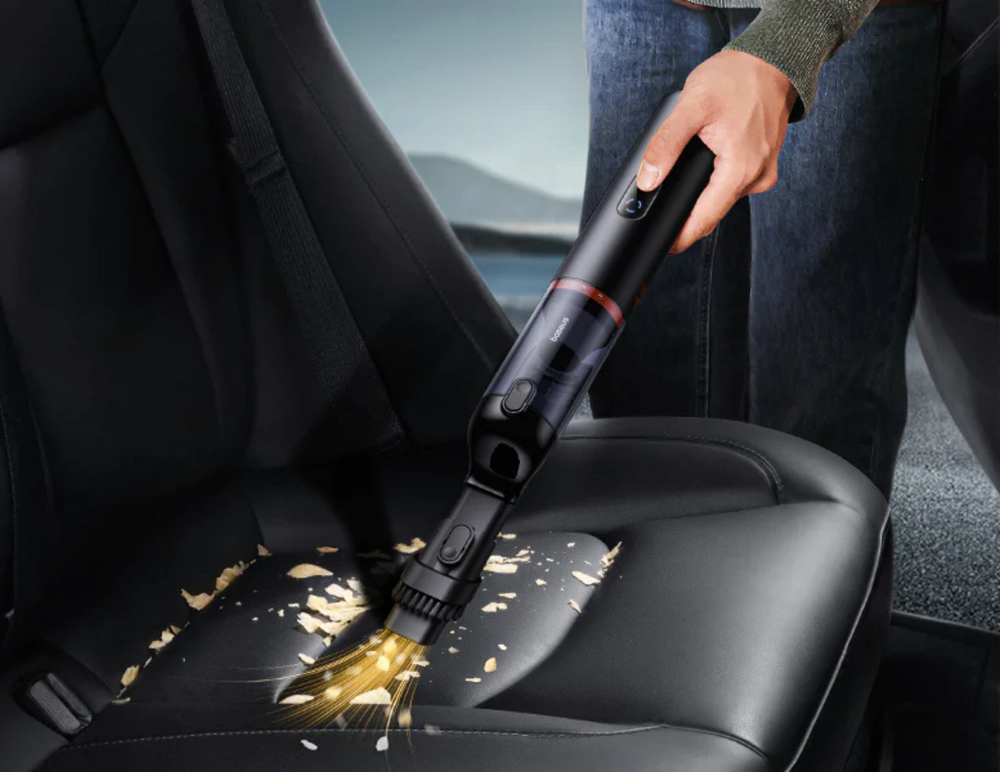 Baseus A5 Car Vacuum Cleaner being used to clean tight spaces in a car interior.