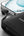 Black Belkin BoostCharge BPB021hq 10K 20W power bank with USB-C cable from Thabthaba Store connected to a smartphone on a light gray background