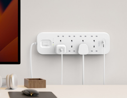 Mounted Belkin Surge Protector SRB003af2M on a wall with organized cables.