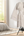 Clothes burner stand holding garments with steam rising for freshening.