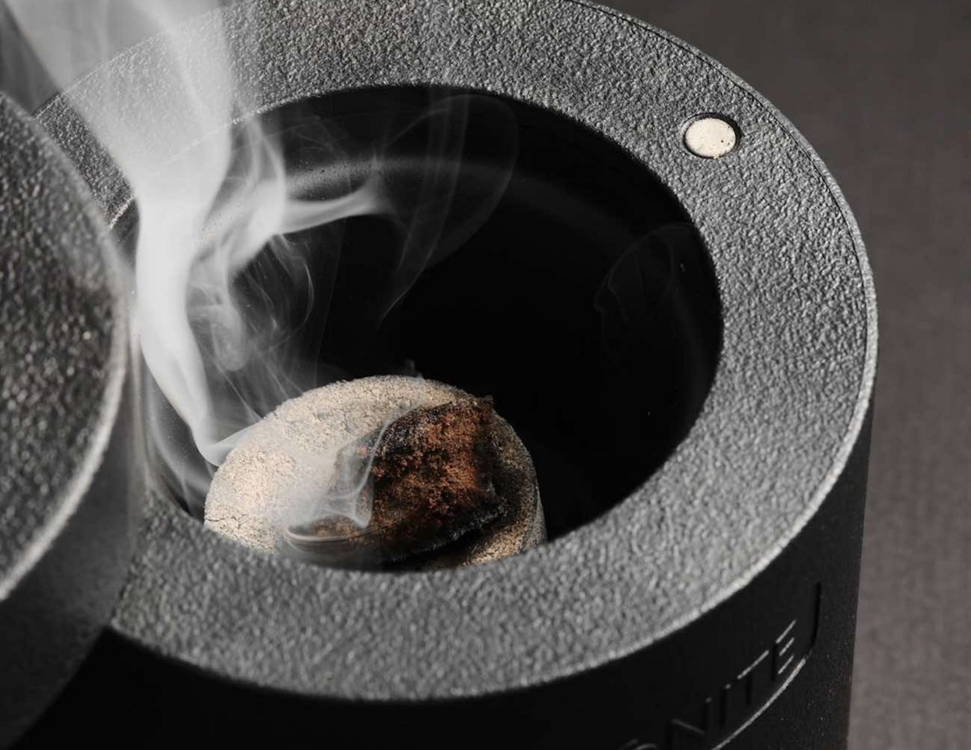 Close-up of the Egnite Electronic Incense Burner’s heating surface with a charcoal disc placed on top.