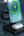 Close-up of the EGO MagCooler charging iPhone, Apple Watch, and QI headset simultaneously.