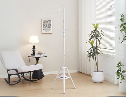 Elegant vertical cloth burner stand white with triangular base on a wooden floor.