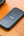 SanDisk Portable SSD 1TB SDSSDE30-1T00-G26 on a desk beside a laptop.
