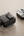 Wireless charging AirPods 4 inside SwitchEasy Rugged Shield AirPods 4 Case.